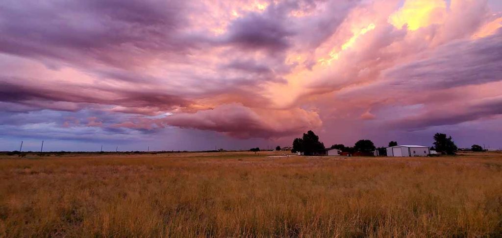 sunset colors in storm clouds over Texas landscape